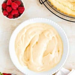 Easy Eggless Pastry Cream in a plate with berries and tart shell