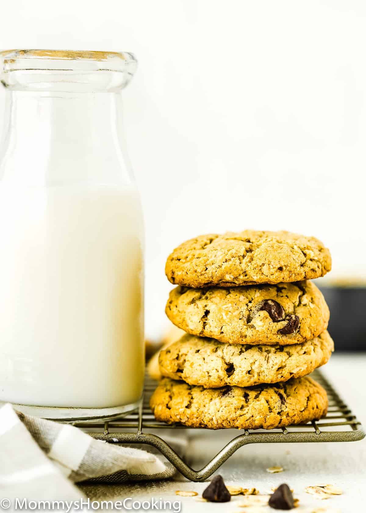 stack of Eggless Oatmeal Cookies with a glass of milk.