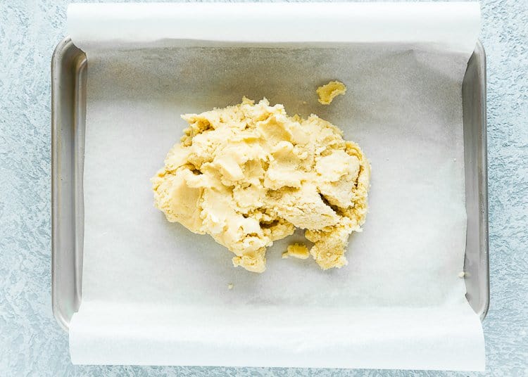 dough to make lemon bar crust in a baking pan.