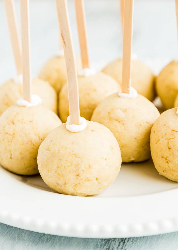 Eggless Homemade Cake Pops in a wooden stick in a white plate. 
