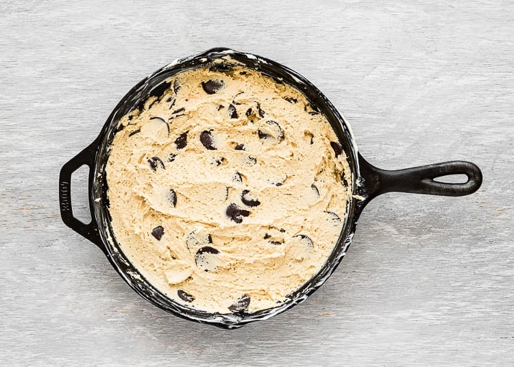 egg-free chocolate chip cookie dough evenly spread in skillet. 