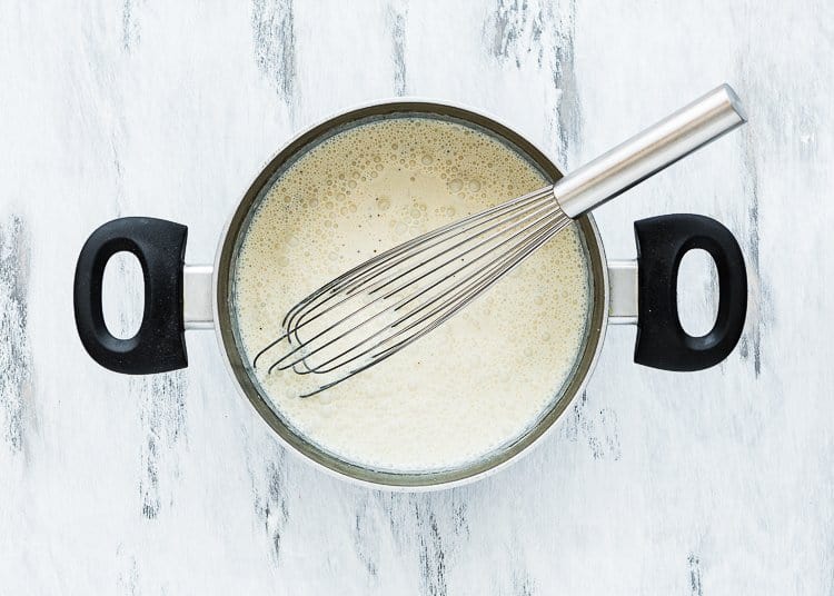 egg-free creme brulee in a saucepan with a whisk.