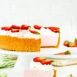 Best No-Bake Strawberry Cheesecake decorated with whipped cream and fresh strawberries