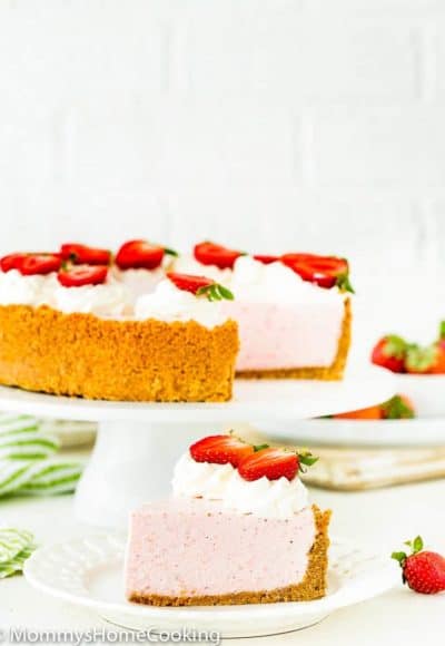 Best No-Bake Strawberry Cheesecake decorated with whipped cream and fresh strawberries