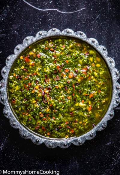 Chimichurri Sauce in a plate over a black surface.