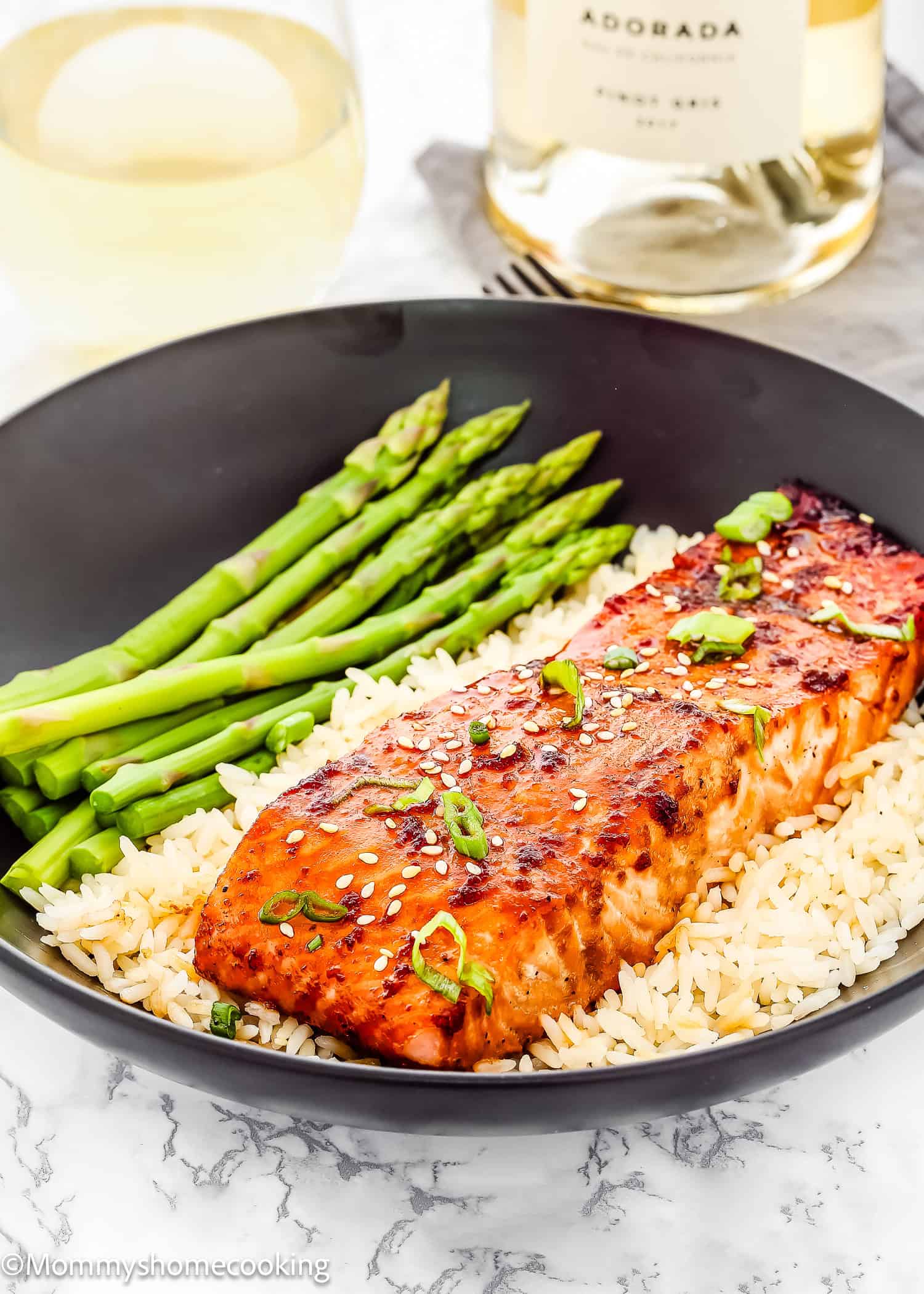 quick and easy baked teriyaki salmon in a plate with rice and asparagus.