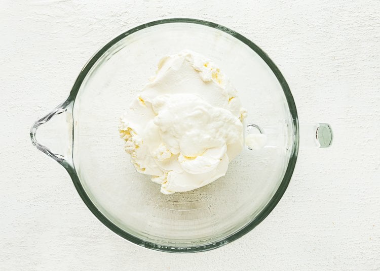 cream cheese and sour cream in a stand mixer bowl. 