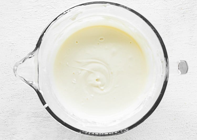 cream cheese, sour cream and sweetened condensed milk in a stand mixer bowl. 