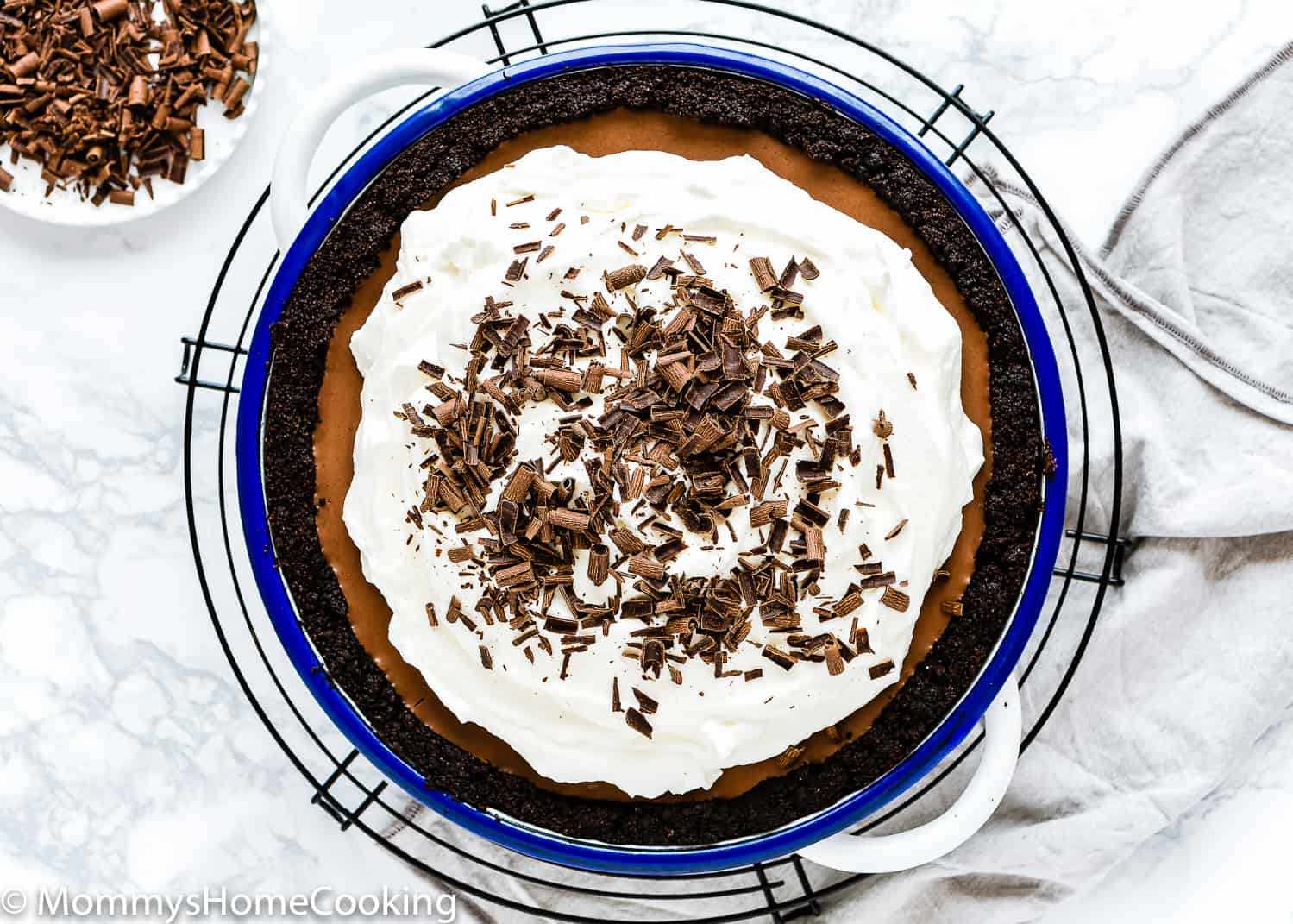 No-Bake Eggless Chocolate Cream Pie with whipped cream a chocolate shavings.