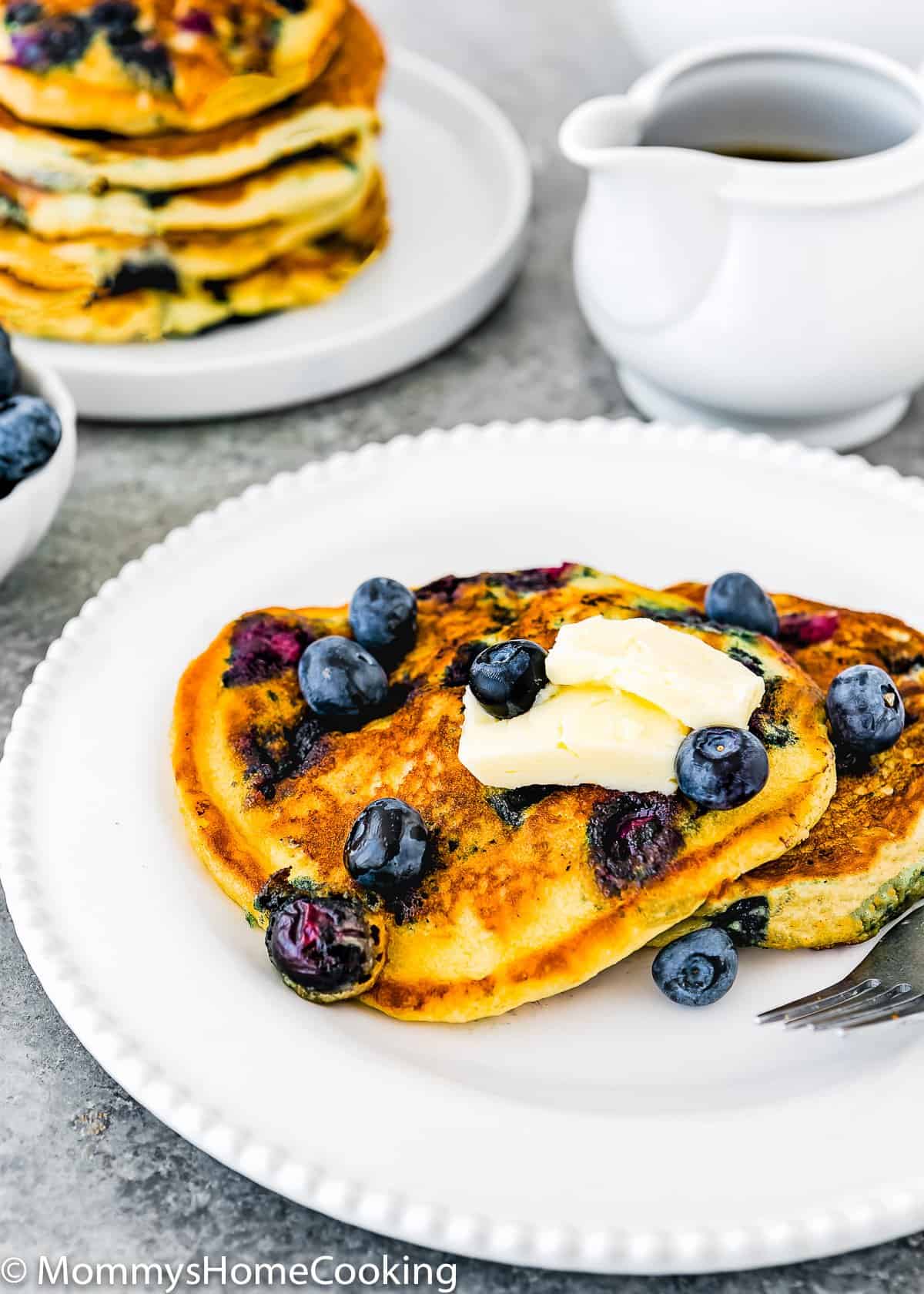 Eggless Blueberry Pancakes with fresh blueberries and butter in a plate 