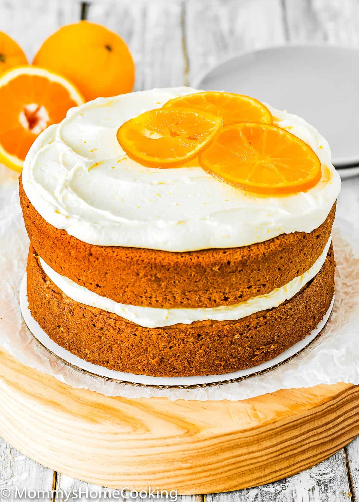 Eggless Orange Cake with orange frosting and candied oranges on top. 