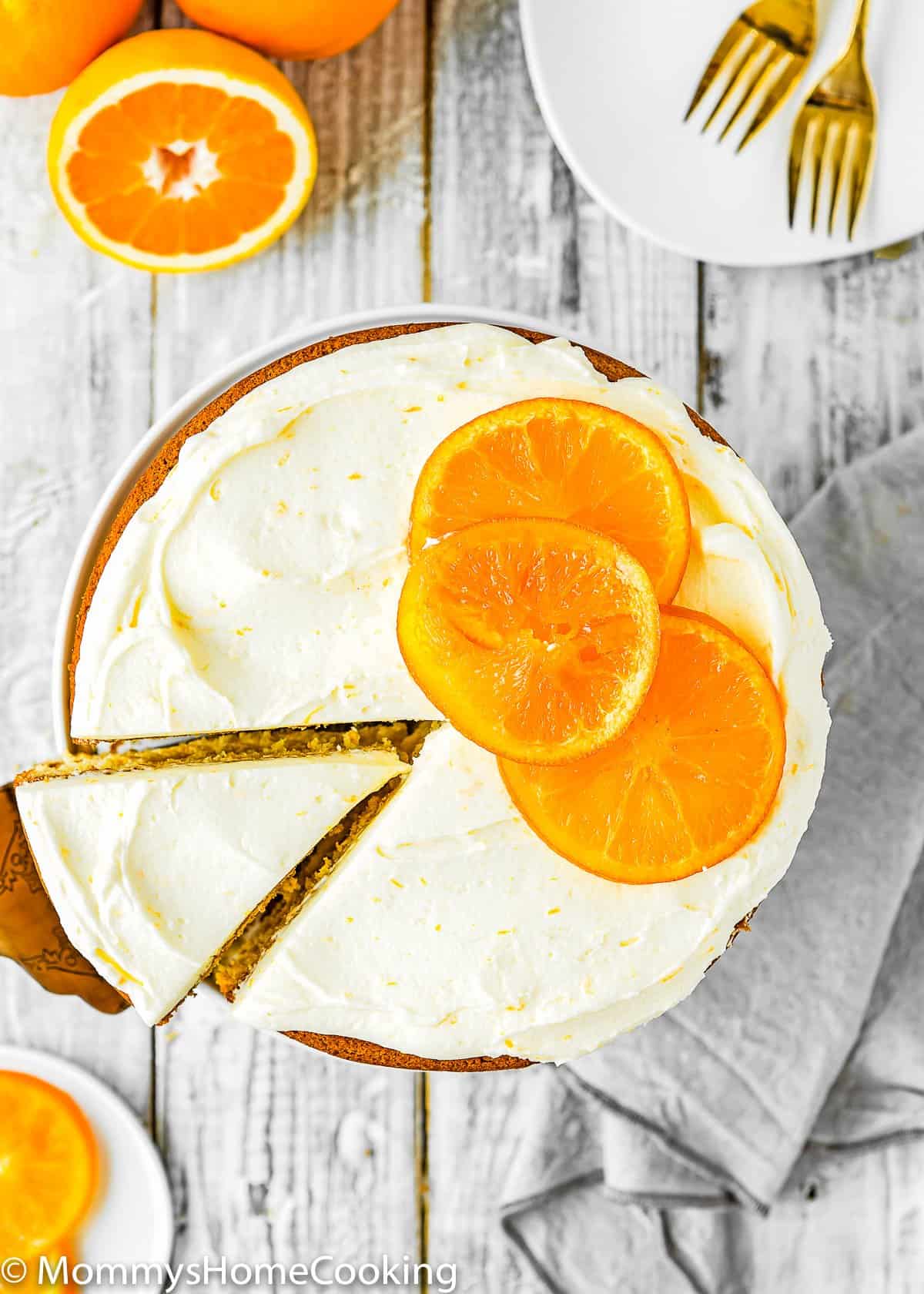 overhead view of a Eggless Orange Cake being cut