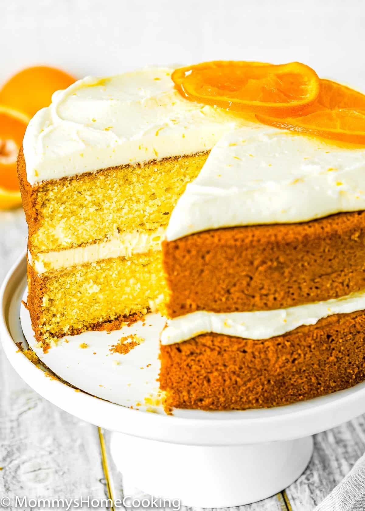 sliced Eggless Orange Cake on a cake stand