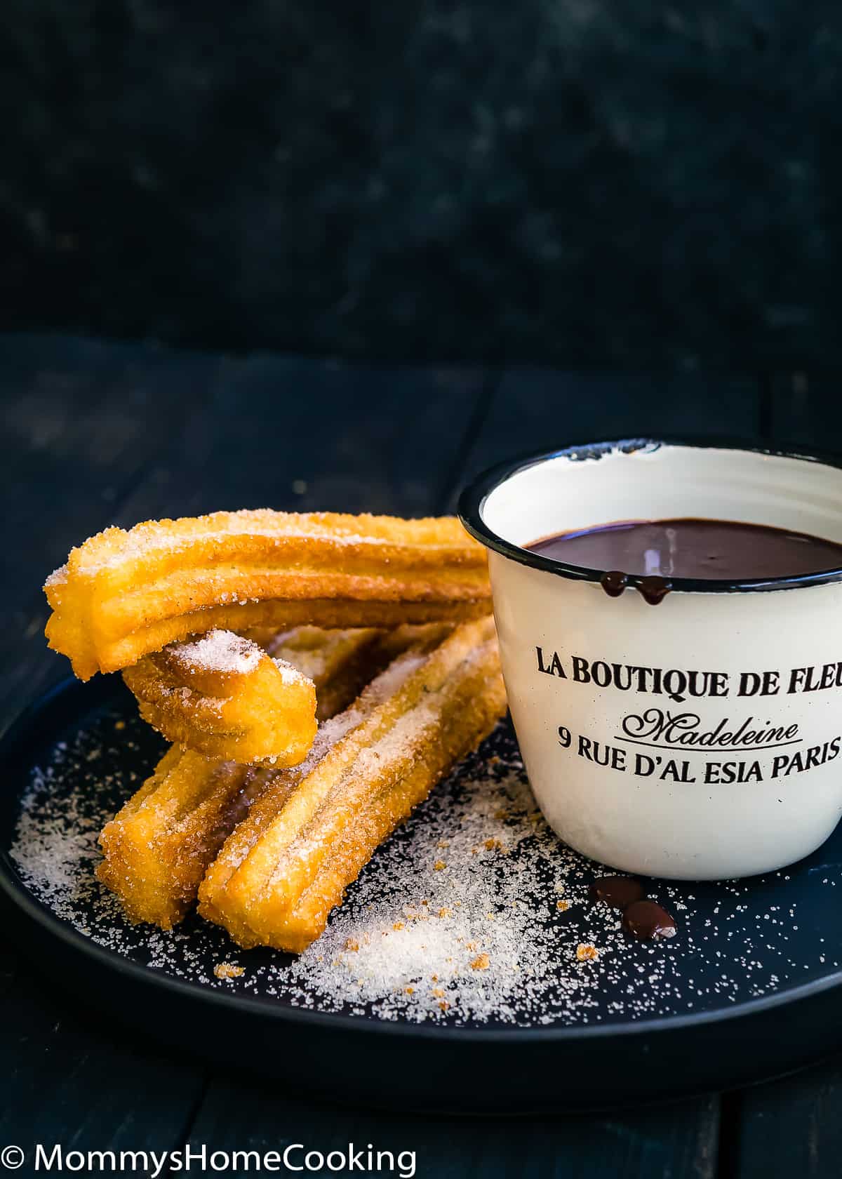 fried homemade churros with chocolate sauce on the side on a plate