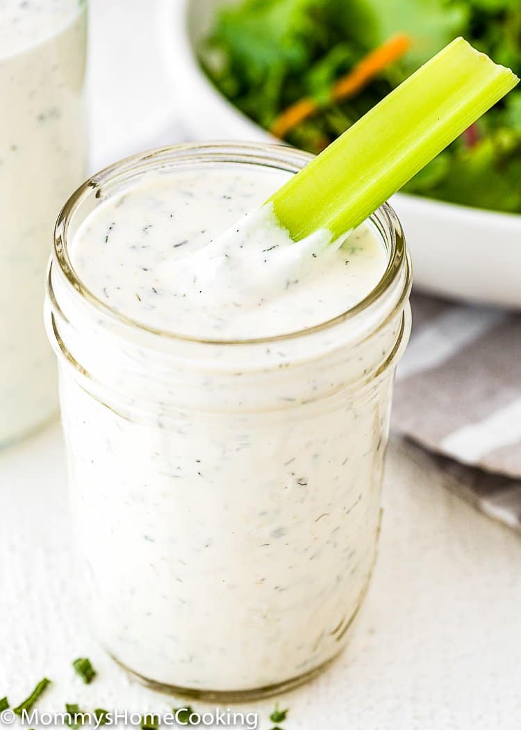 Homemade Eggless Ranch Dressing/sauce in a glass jar with a celery stick