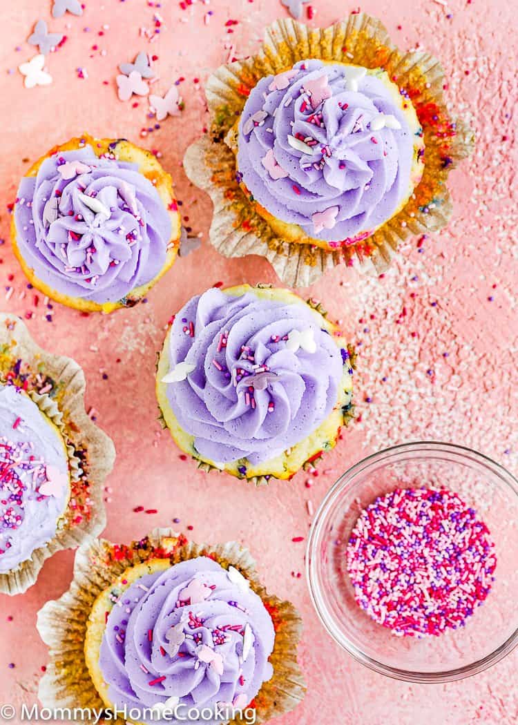 Eggless Confetti Cupcakes over a pink surface