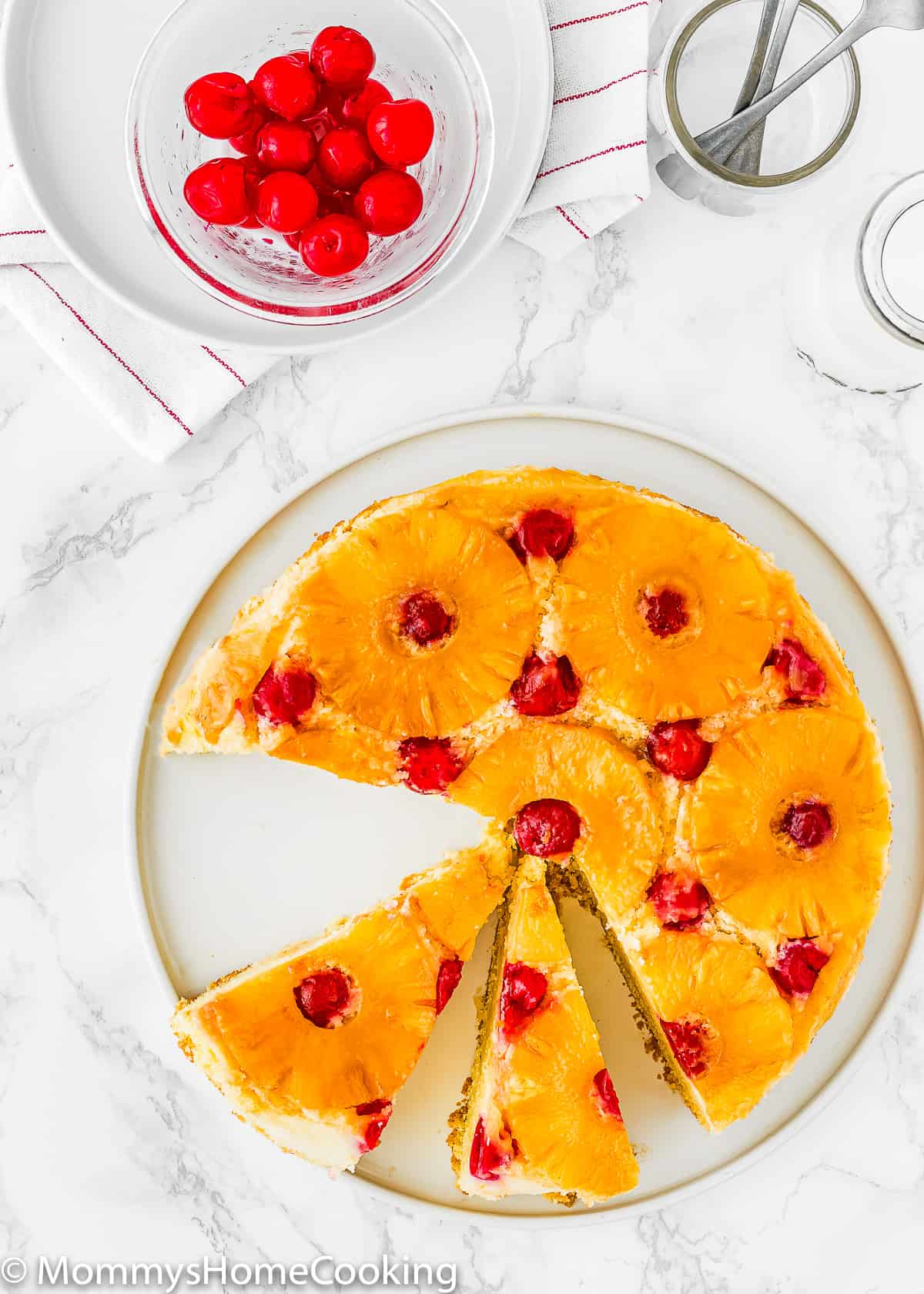 overhead view of an Eggless Pineapple Upside Down Cake sliced.