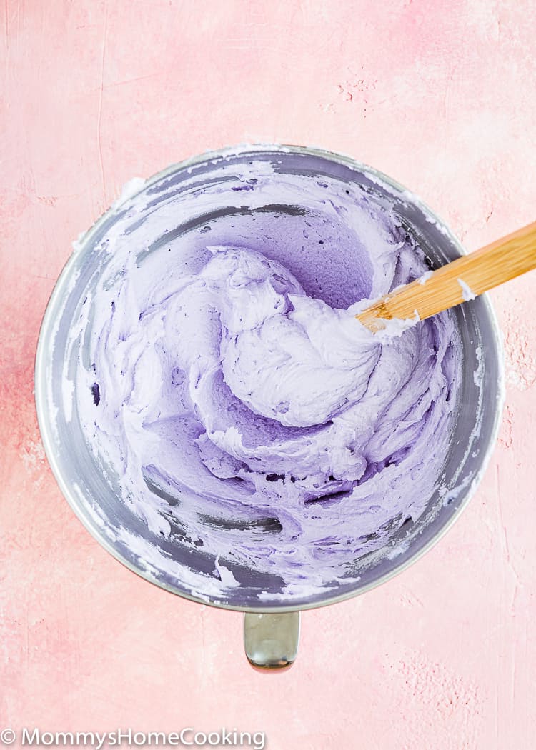 purple buttercream in a bowl with a spatula. 