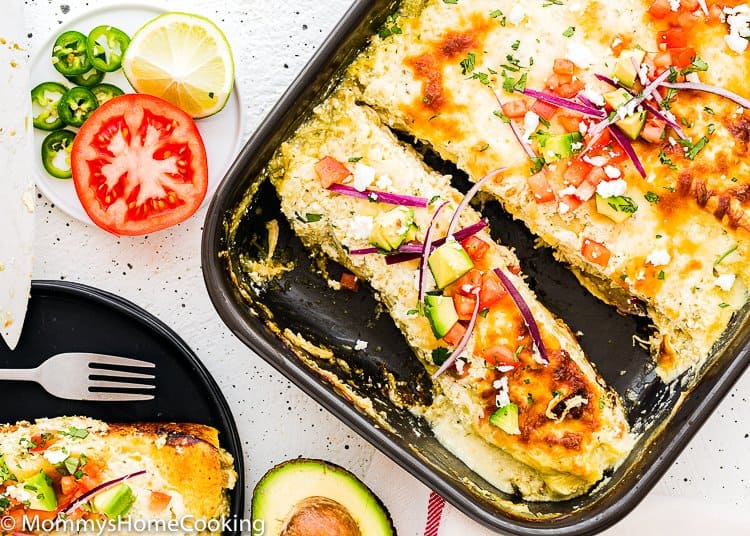 Easy Enchiladas Suizas in a baking dish with a serving plate