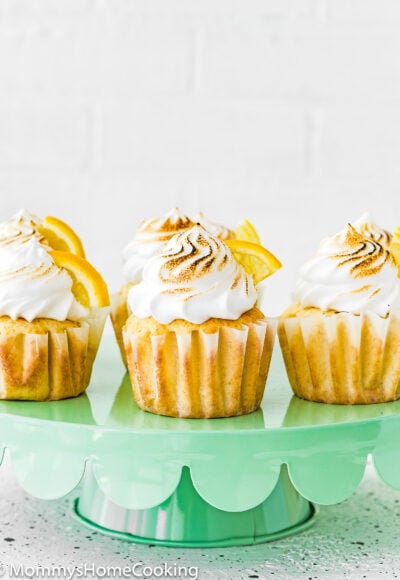 Eggless Lemon Meringue Cupcakes on a cake stand.