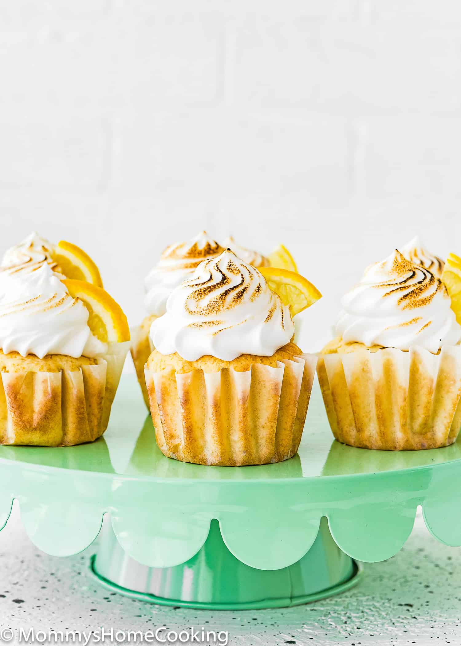 Eggless Lemon Meringue Cupcakes on a cake stand. 