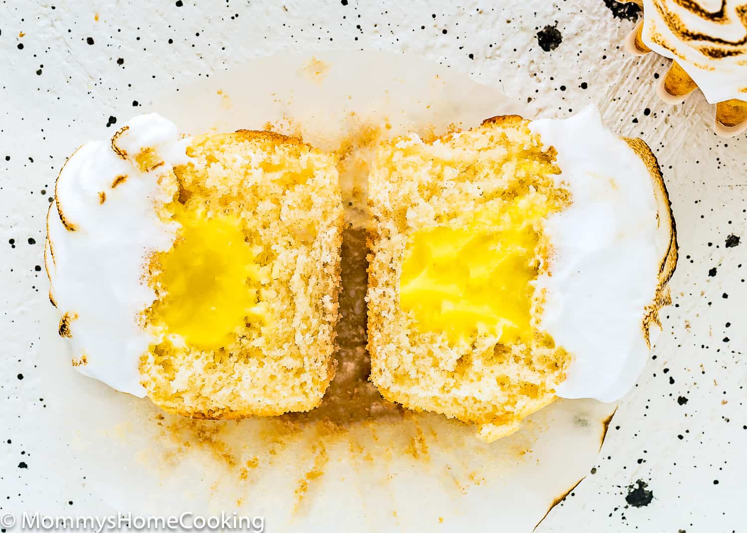 Eggless Lemon Meringue Cupcake open in half showing its inside texture.