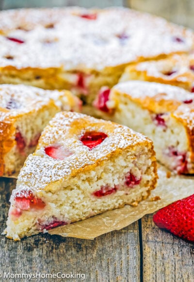 a egg-free strawberry cake slices over a piece of parchment paper.