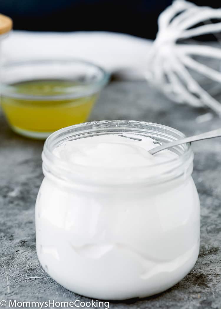 Homemade Eggless Marshmallow Fluff in a glass jar with a spoon