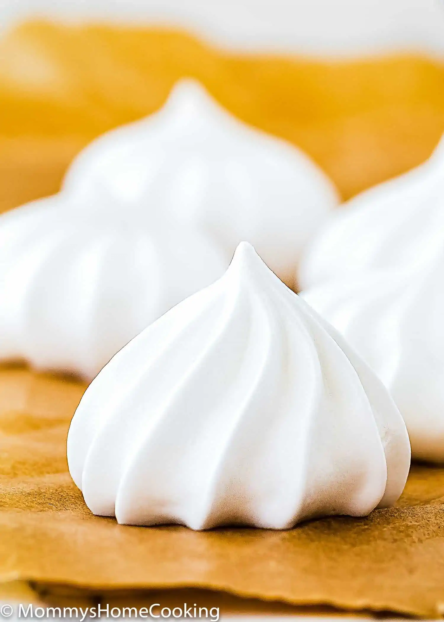 a eggless meringue cookie over a piece of parchment paper.
