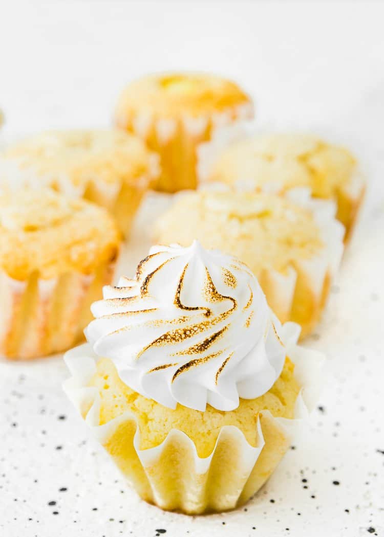 Torched Eggless Lemon Meringue Cupcakes over a white surface. 