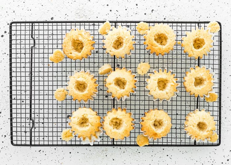 egg-free cupcakes with a hold in the center over a cooling rack. 