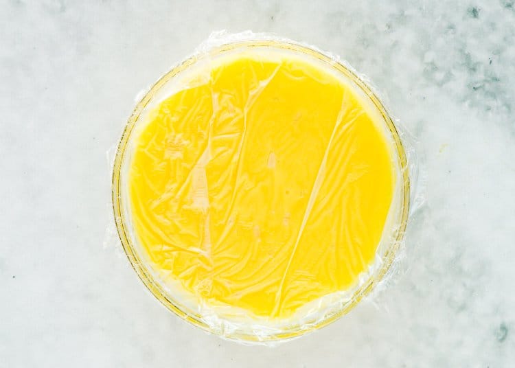 egg-free lemon curd in a bowl covered with plastic wrap. 