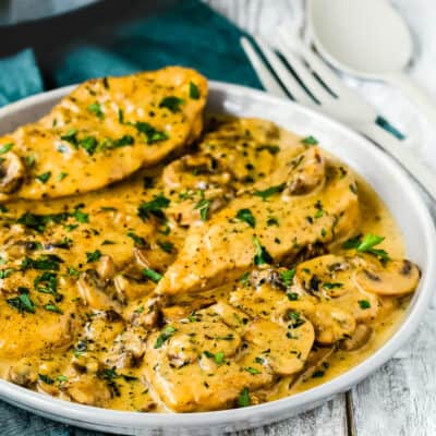 Creamy chicken marsala in a plate garnished with chopped parsley.