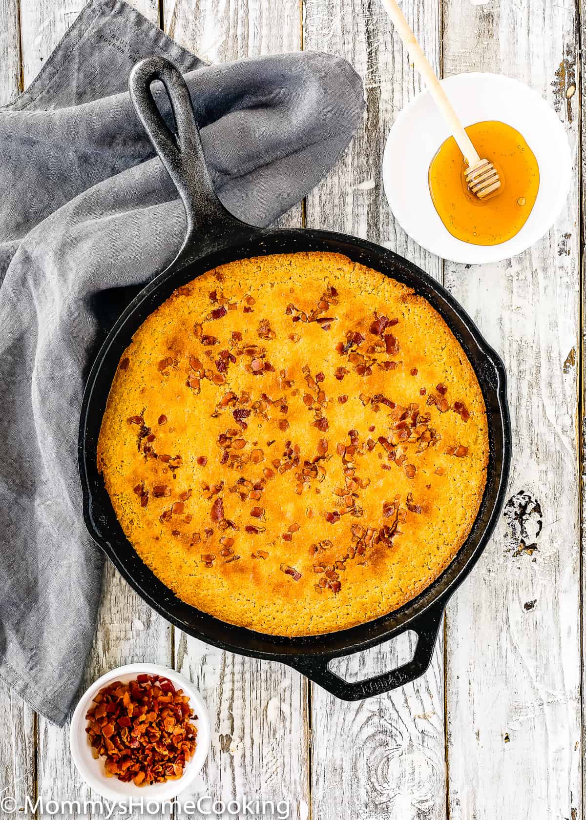 overhead view of a eggless cornbread in a cast iron skillet.
