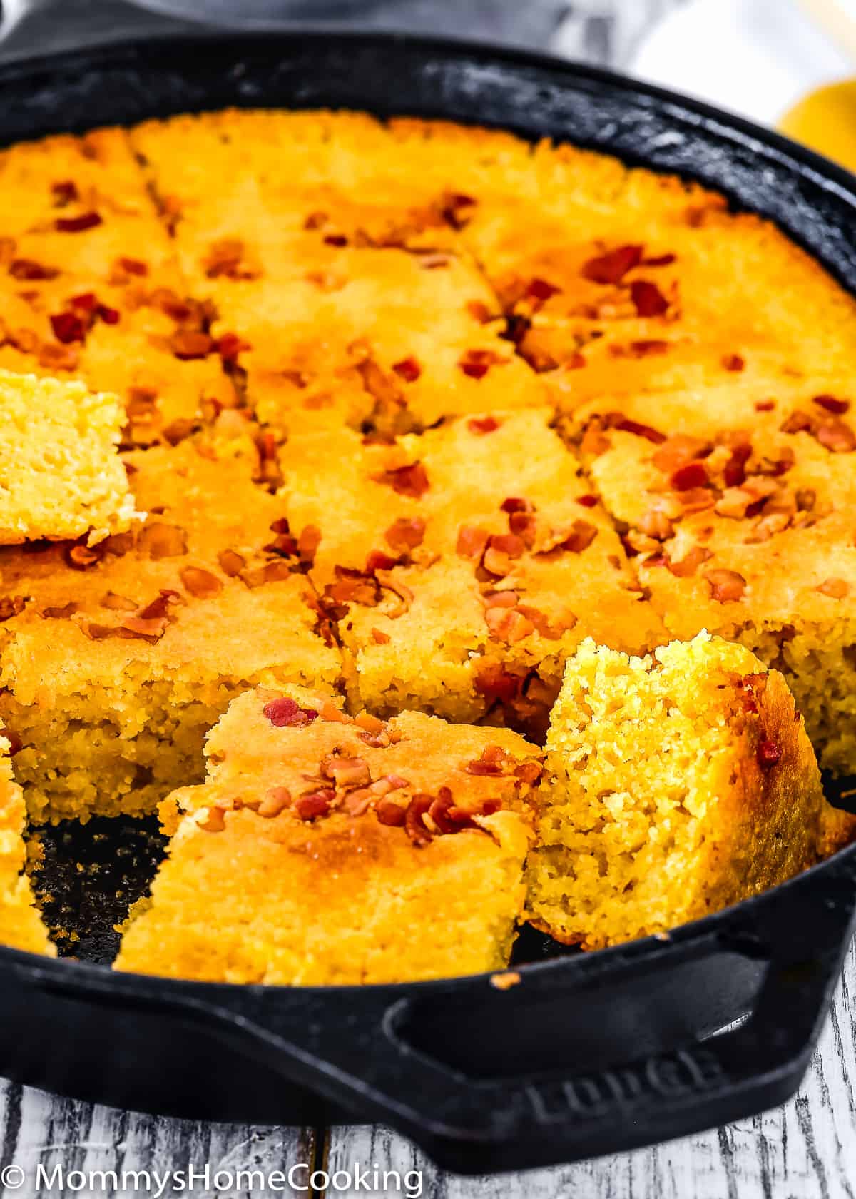 eggless cornbread cut into portions in a cast iron skillet