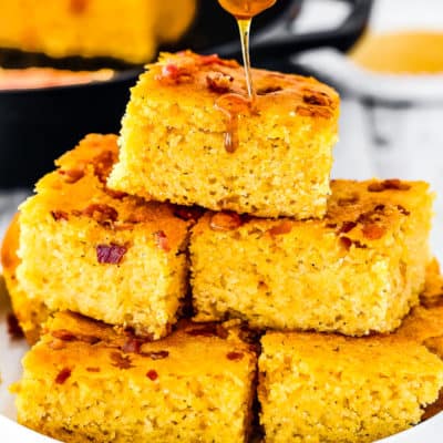 eggless cornbread in a plate with honey being pour on top