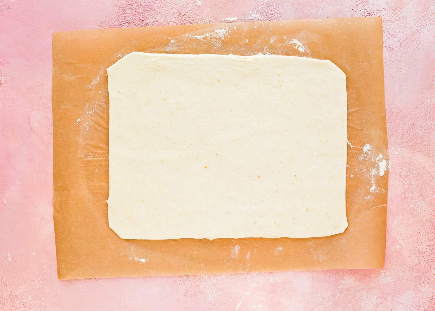 egg-free dough rolled into a rectangle over parchment paper. 