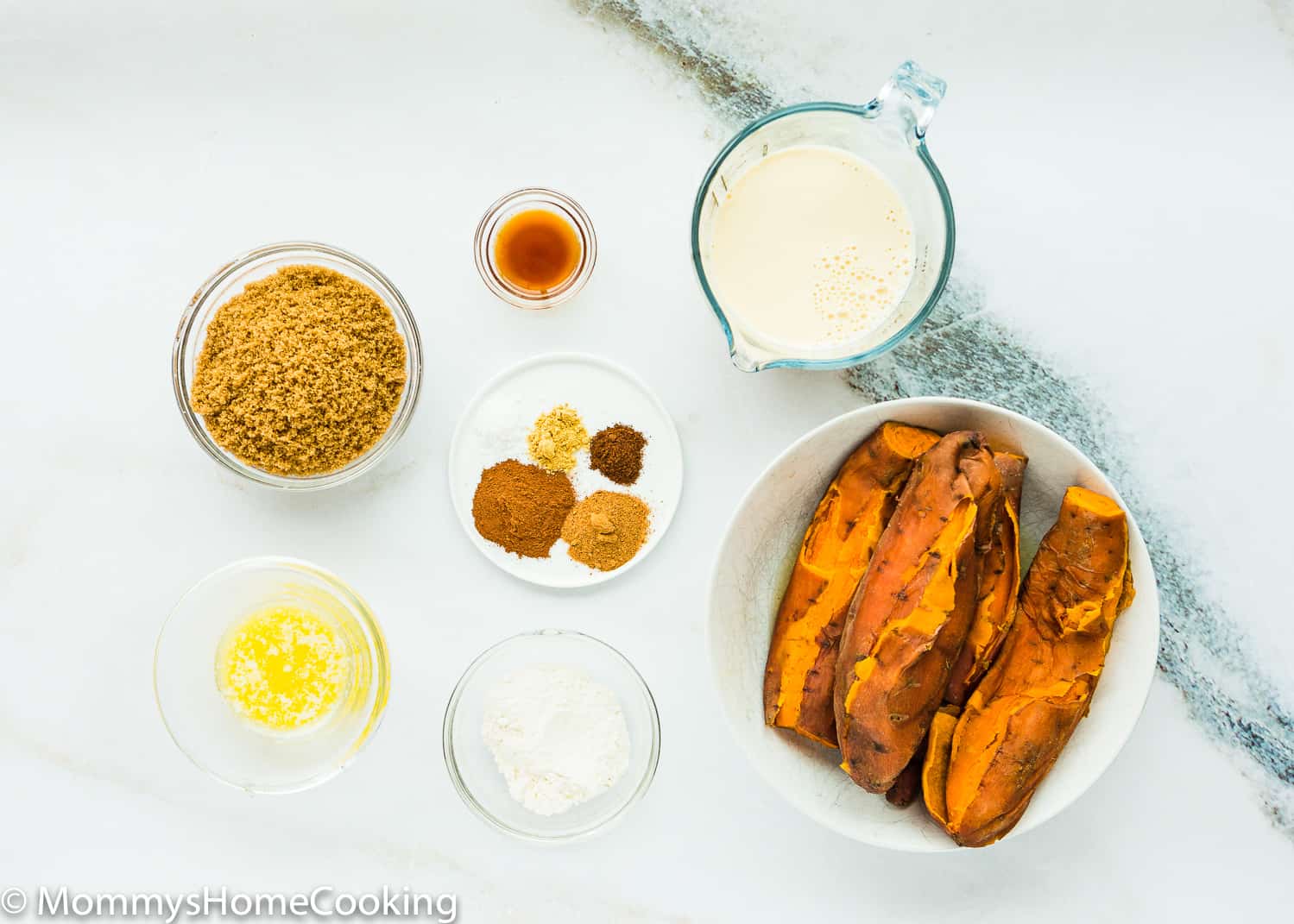 Easy Eggless Sweet Potato Pie Ingredients over a marble surface