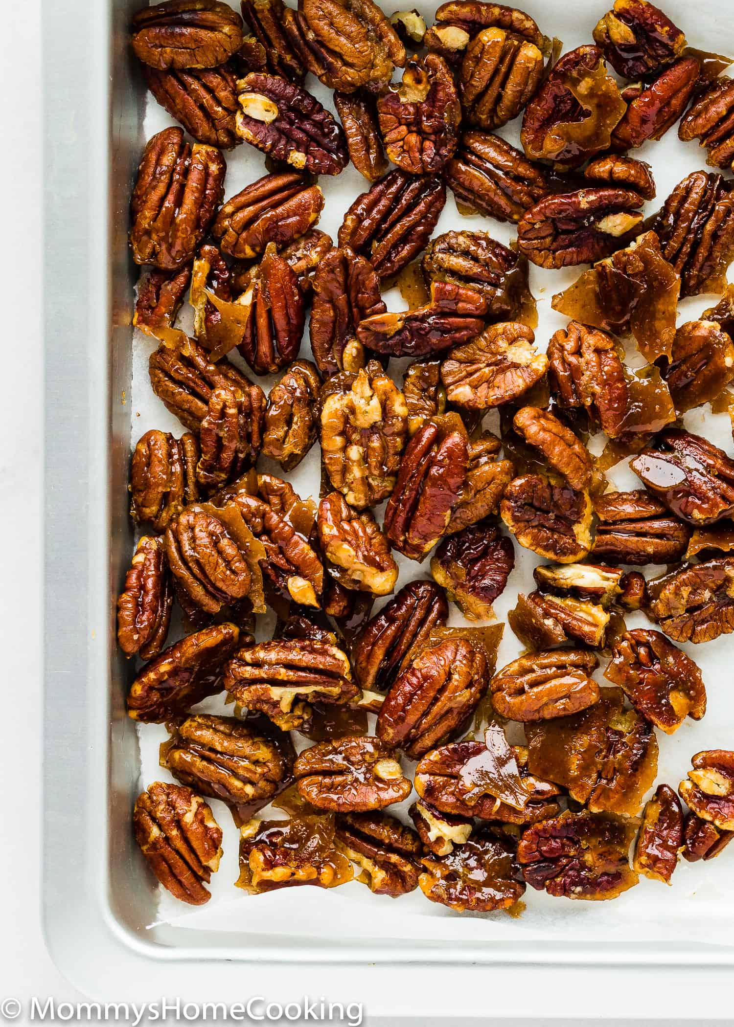 homemade candied pecans on a baking sheet.