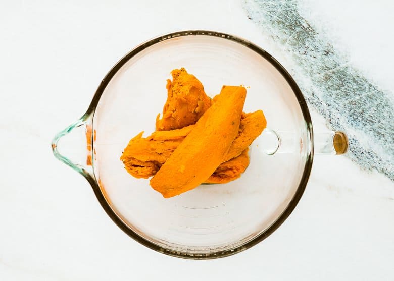 cooked sweet potatoes in a stand mixer bowl. 