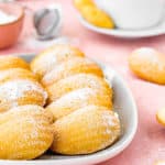 Eggless madeleines on a plate Sprinkled with powdered sugar