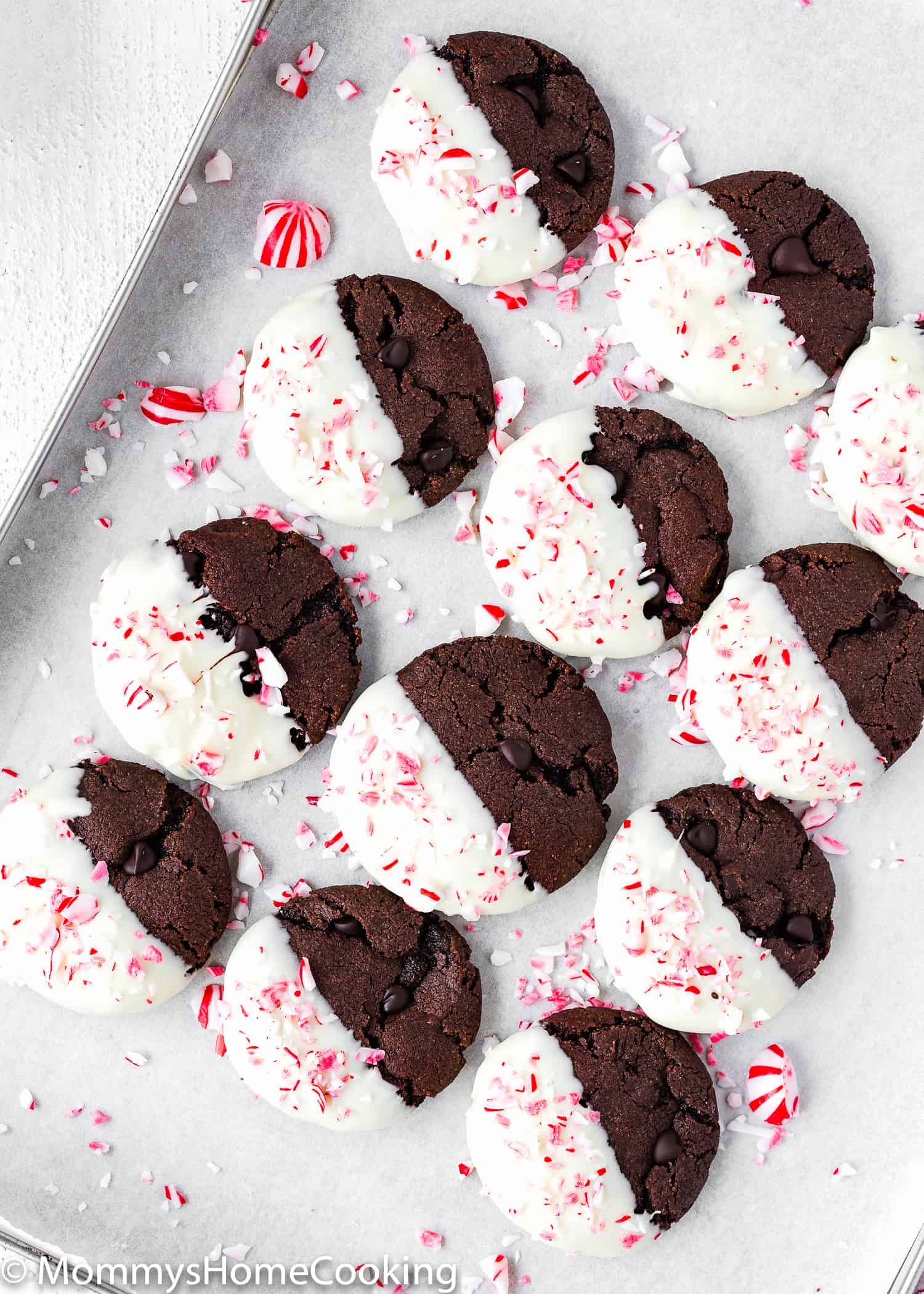 Eggless Triple Chocolate Peppermint Cookies on a baking tray decorated with crushed candy canes