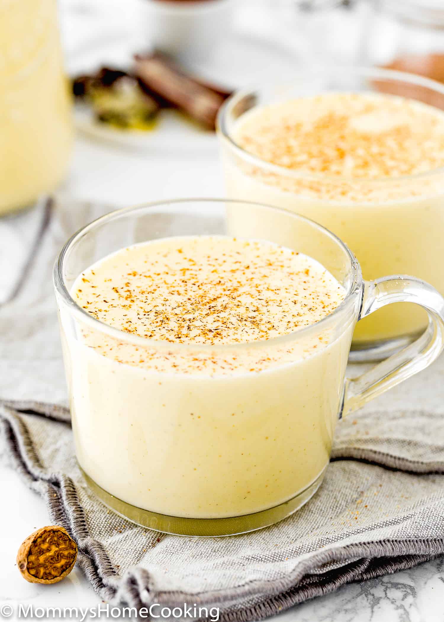 a cup of homemade eggless eggnog with cinnamon on top.