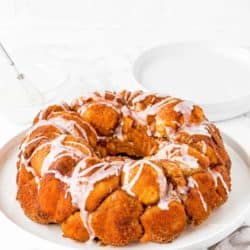 Homemade Eggless Monkey Bread on a plate drizzled with sugar glaze