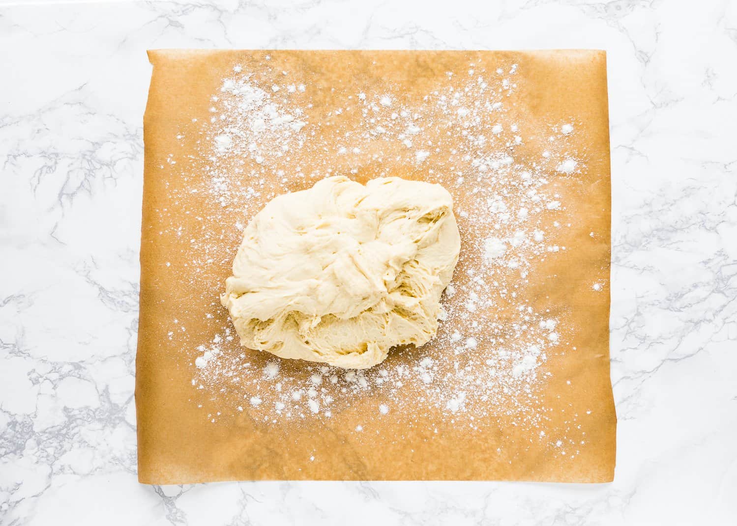 Egg-free monkey bread dough over a pieces of parchment paper. 