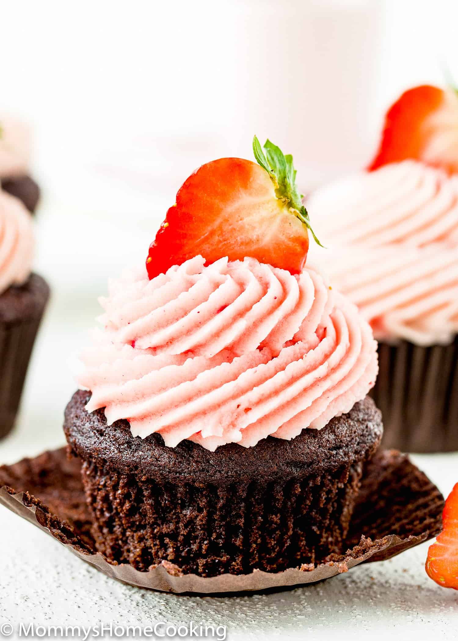 Eggless Chocolate Strawberry Cupcake with strawberry buttercream and a fresh strawberry on top. 