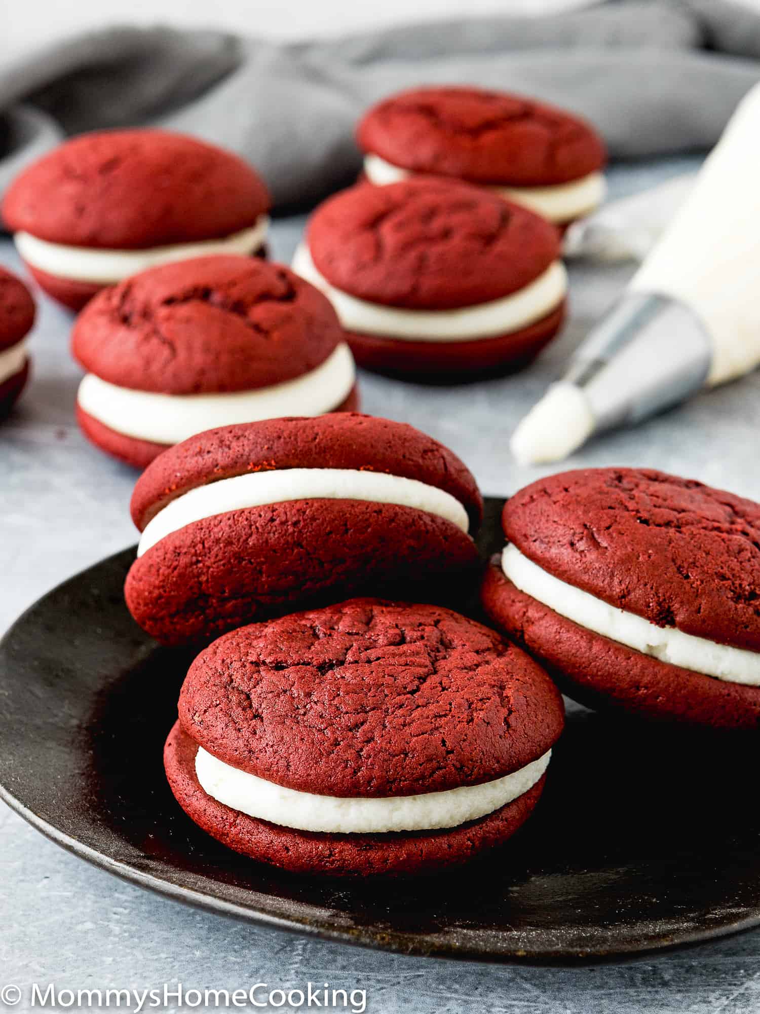 Eggless Red Velvet Whoopie Pies on a black plate