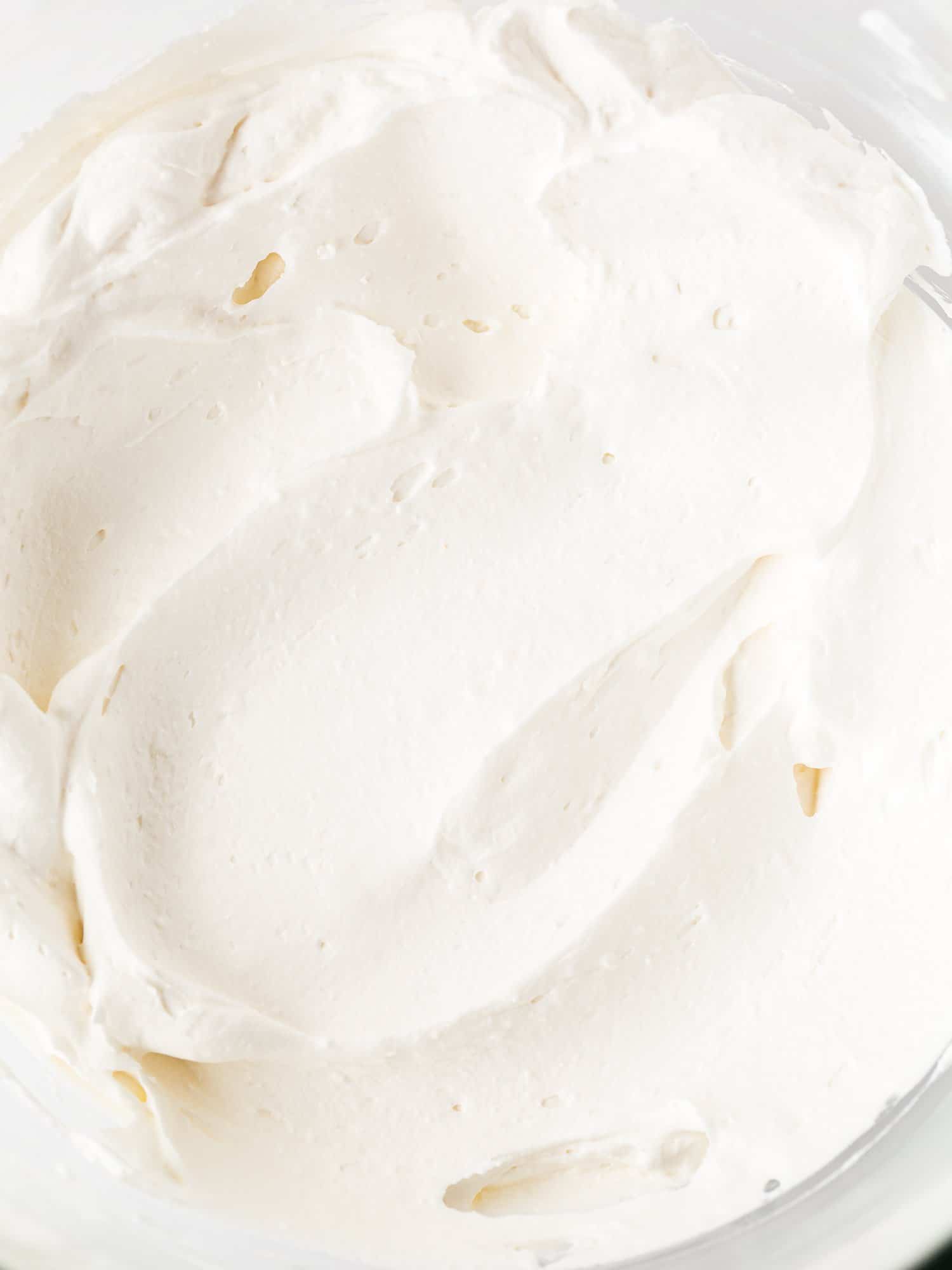 whipped cream for eggless coconut cream pie in a bowl. 