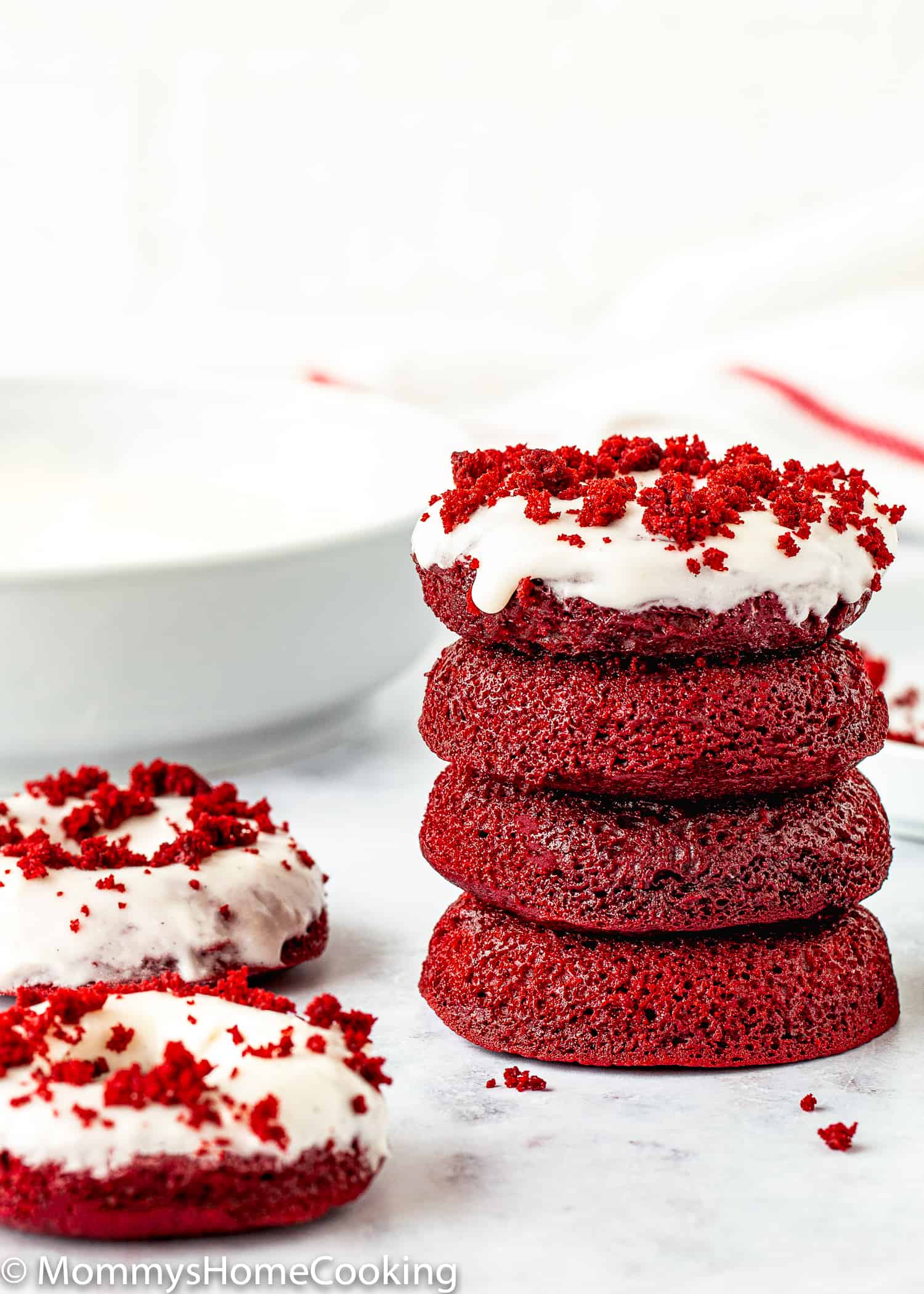 Eggless Red Velvet Donuts stack with cream cheese glaze.