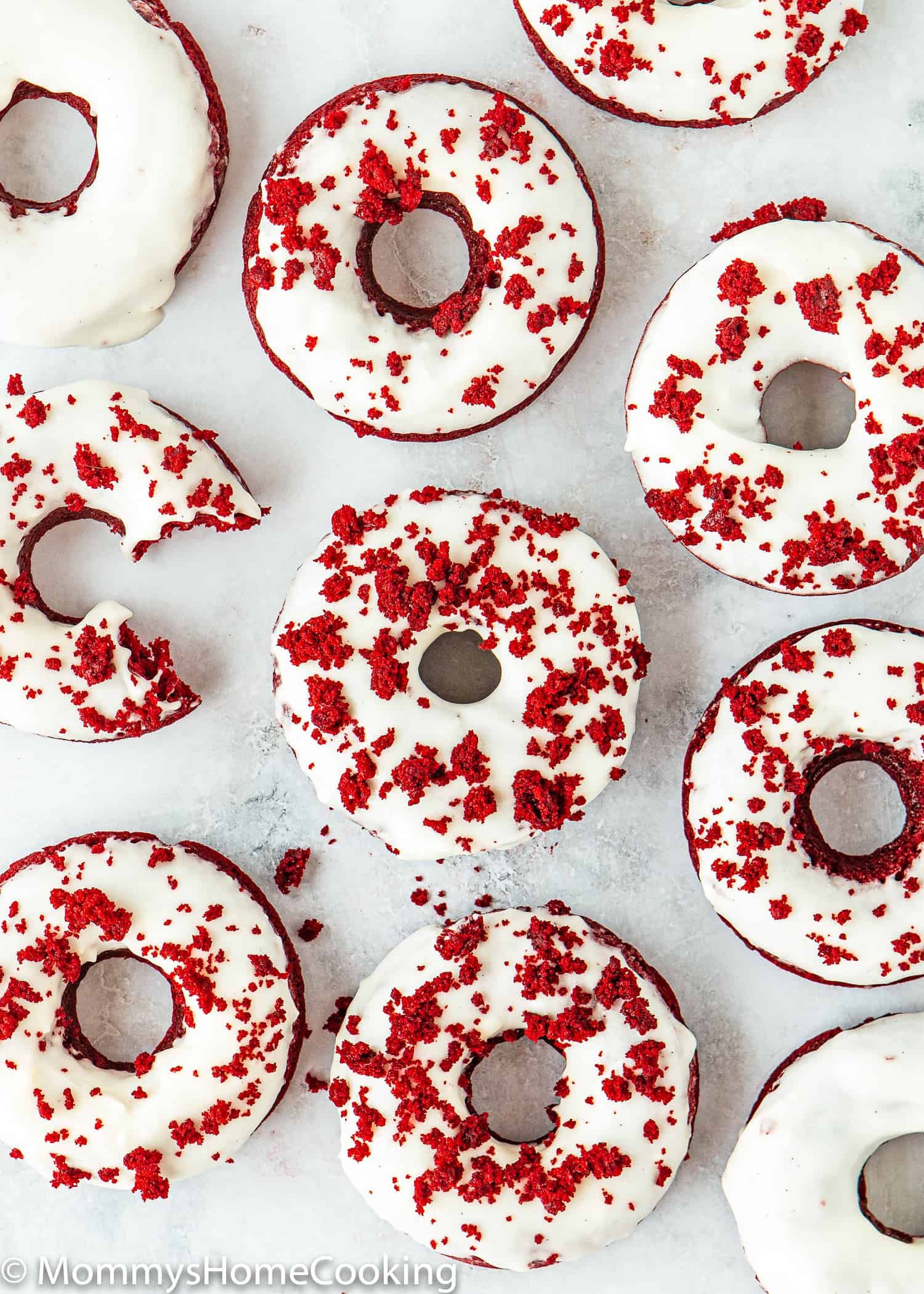 Eggless Red Velvet Donuts over a white surface .